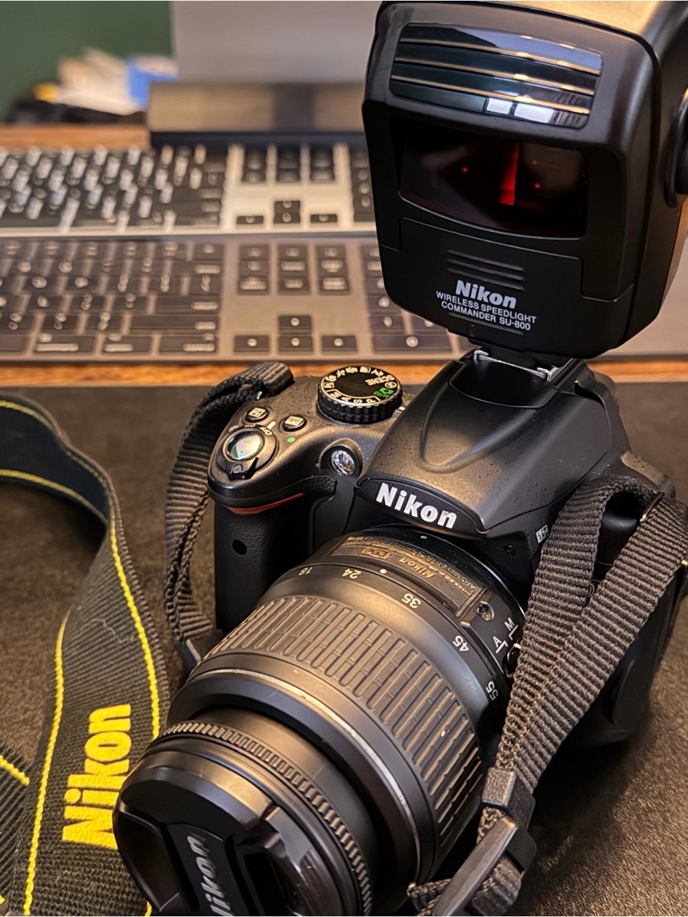 Nikon Black DSLR Camera with Black Lens and Yellow-Accent Strap